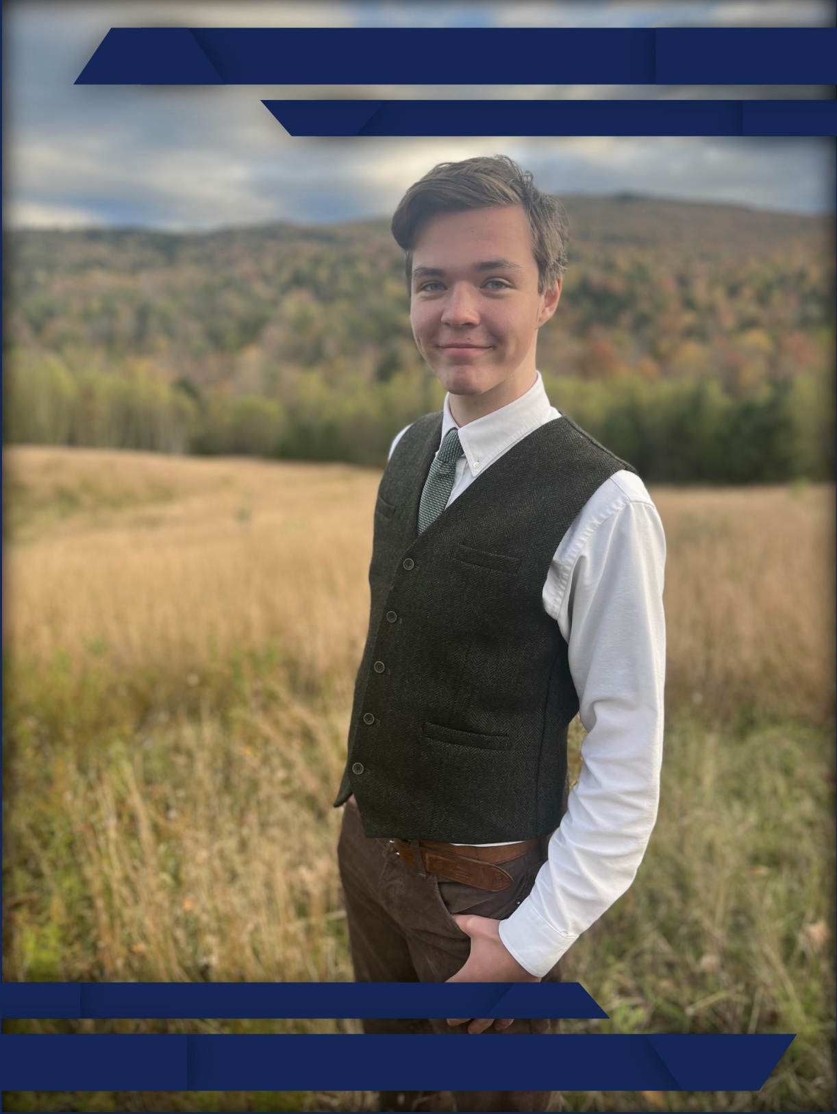 Portrait of owner standing in a field wearing vest
